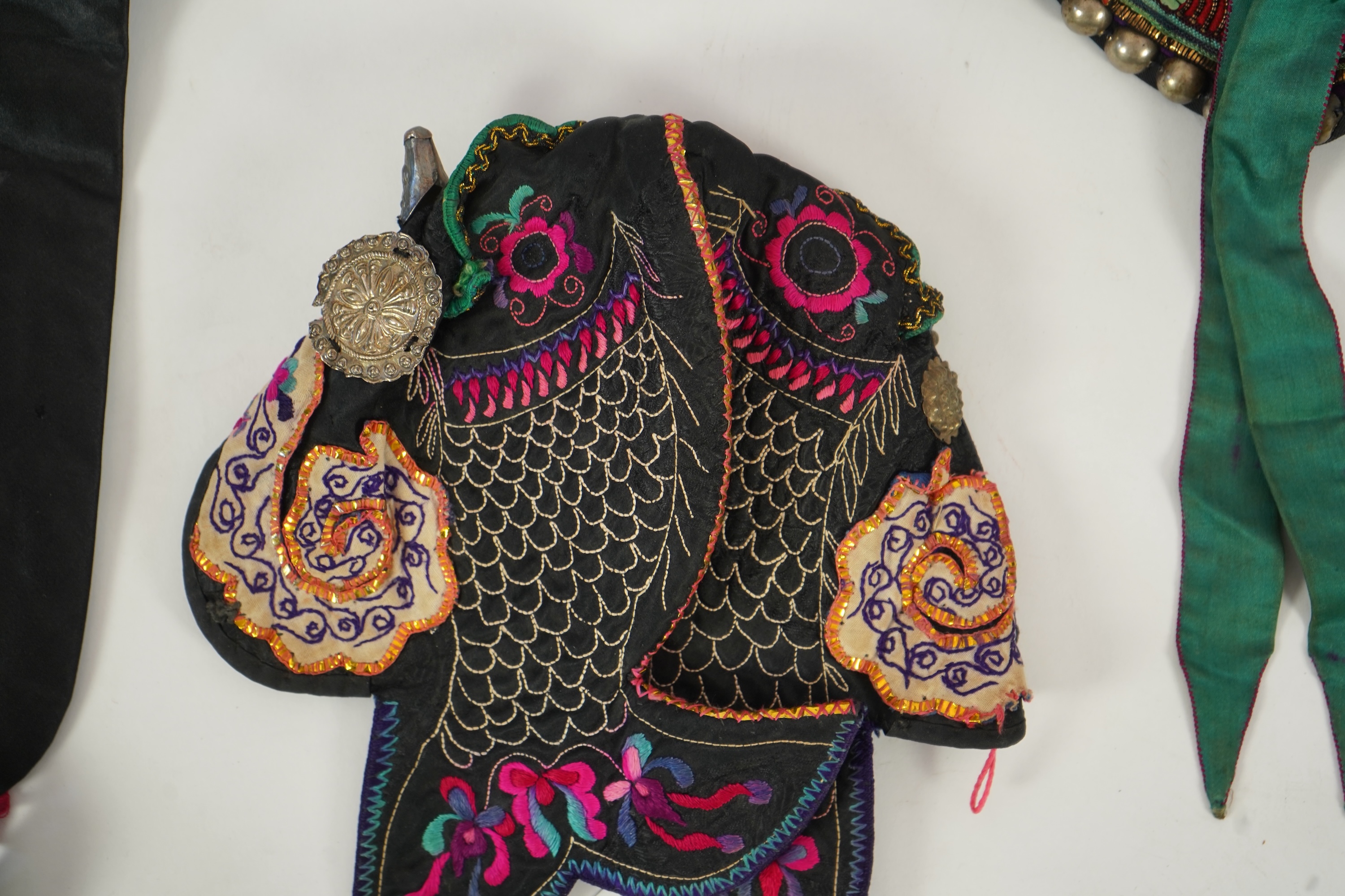 Two Chinese embroidered silk wedding skirts, late Qing, five hats, trousers, two skirt panels and two others, collar and a panel